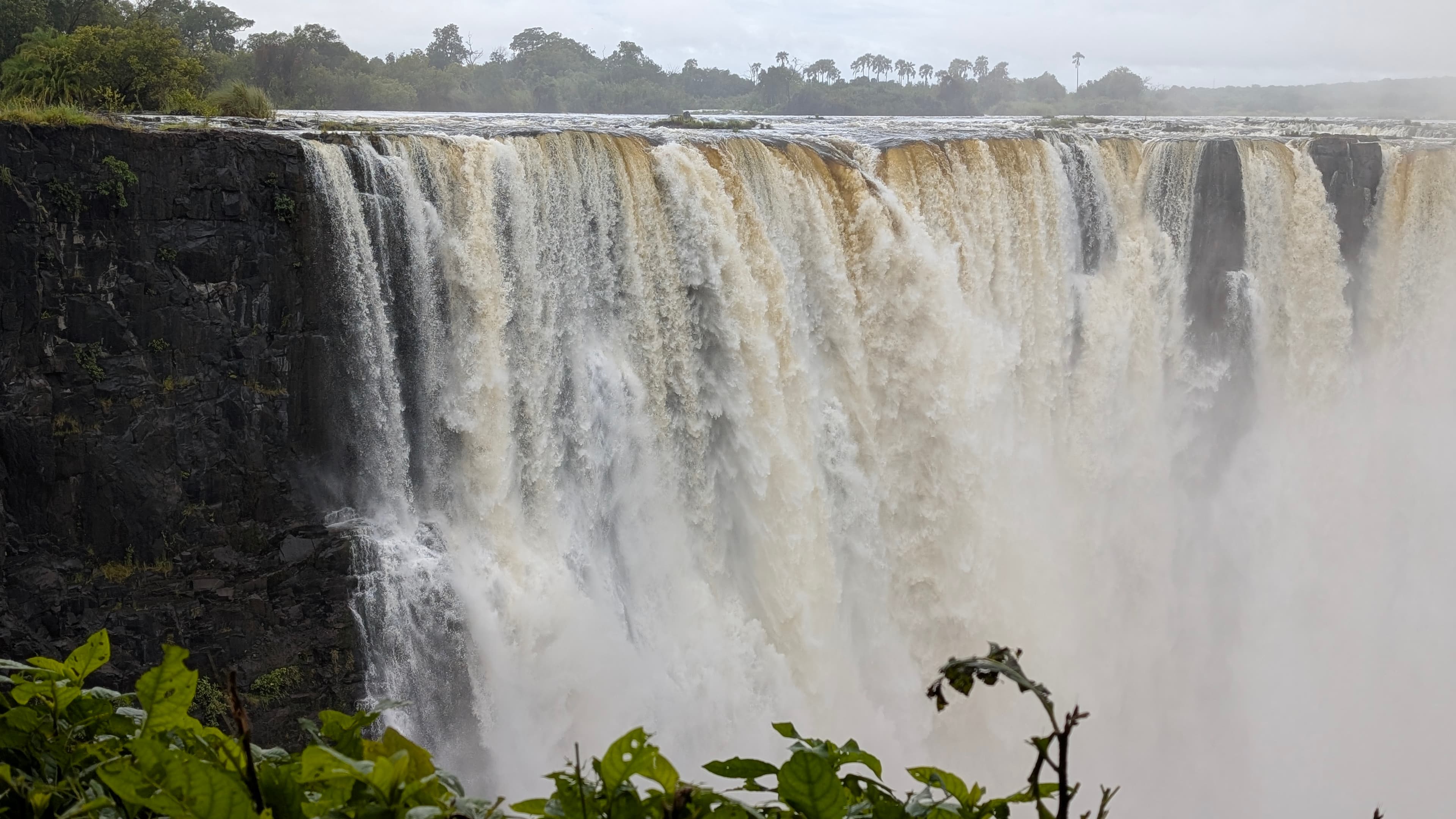 Victoria Falls with a rainbow over the Zambezi gorge